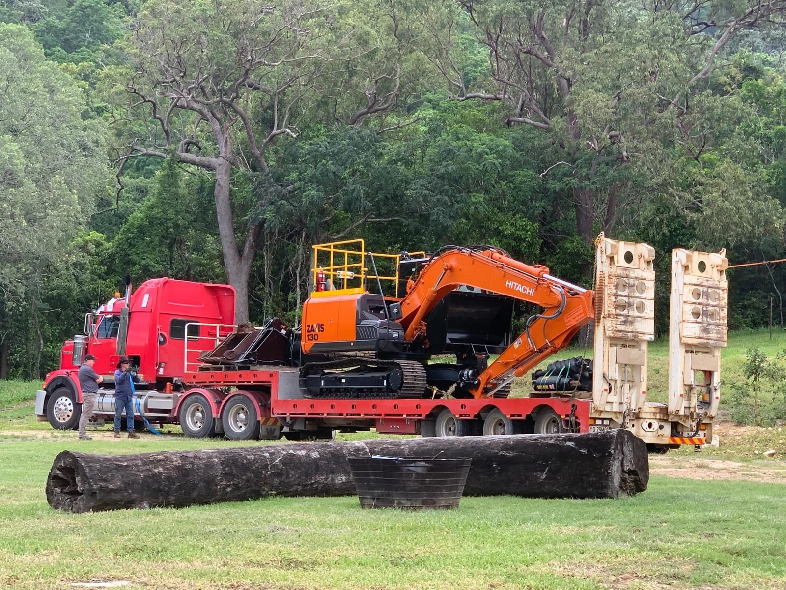 Hitachi excavator loaded on transport truck