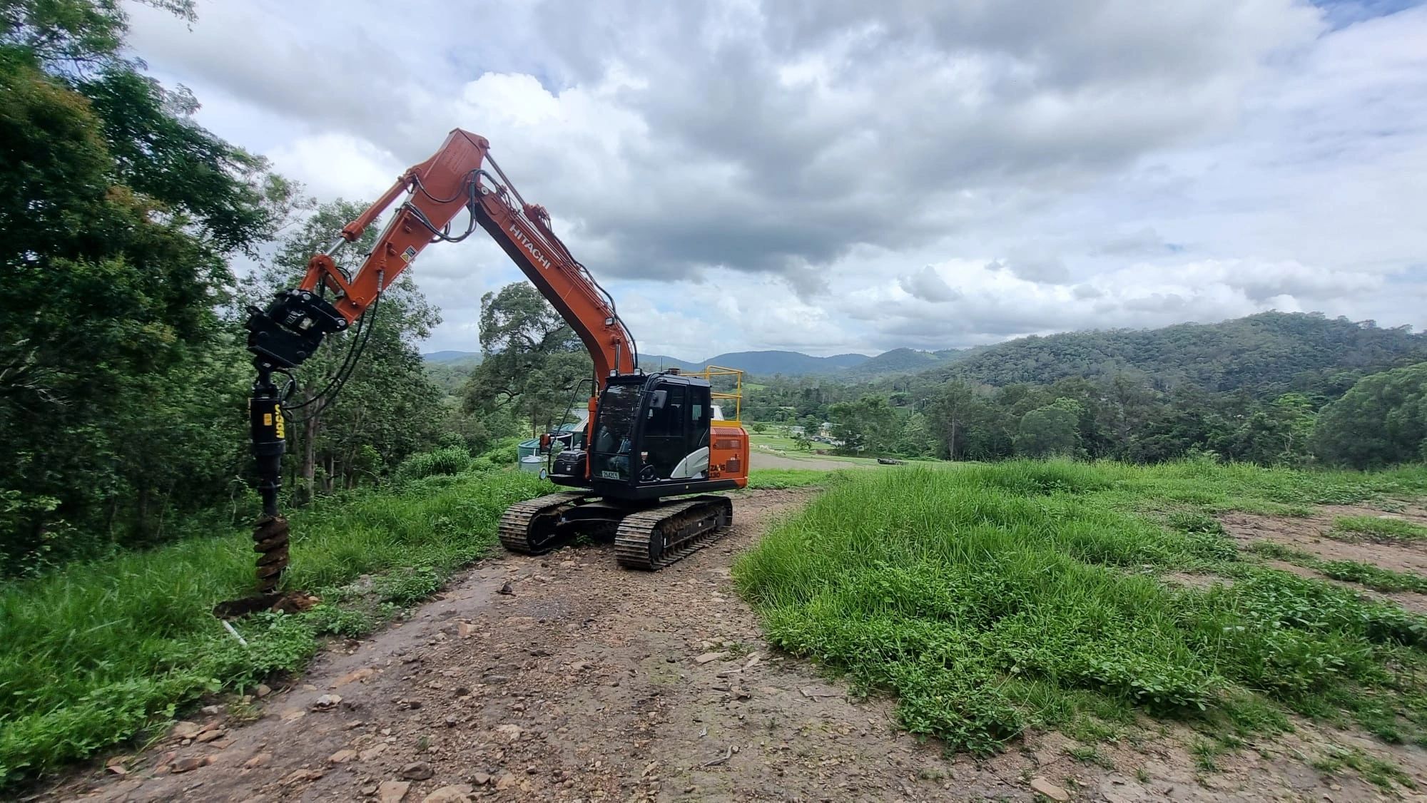 Excavator with drilling attachment on a rural Queensland site